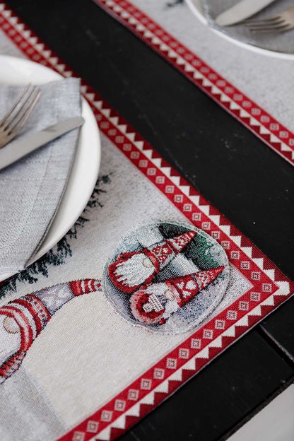 Styled Christmas dining table with tapestry placemats and holiday decorations in the room