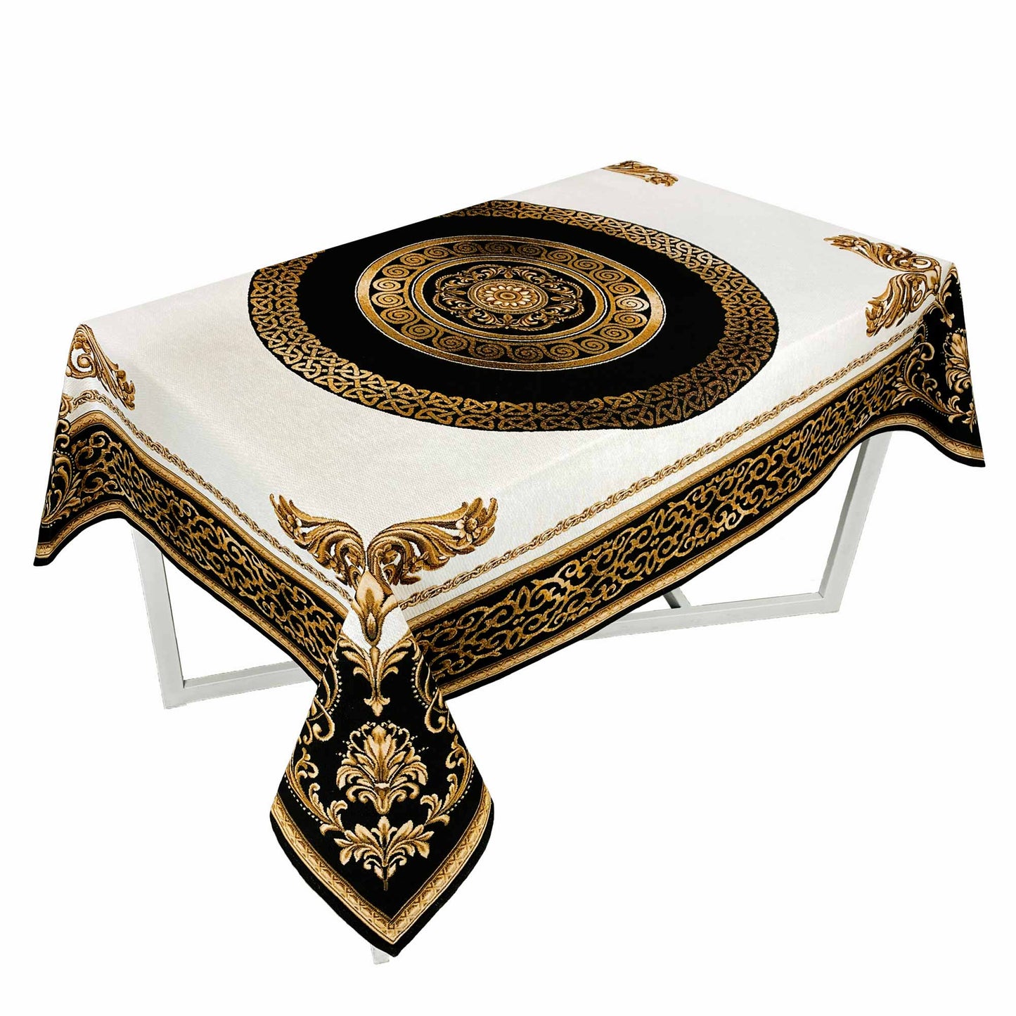 White tablecloth with a black and gold baroque medallion pattern draped over a rectangular table.