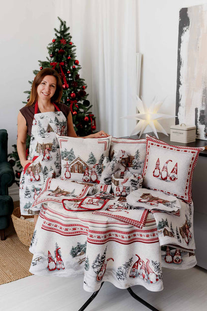 Woman wearing Christmas apron with gnome print near holiday table decor