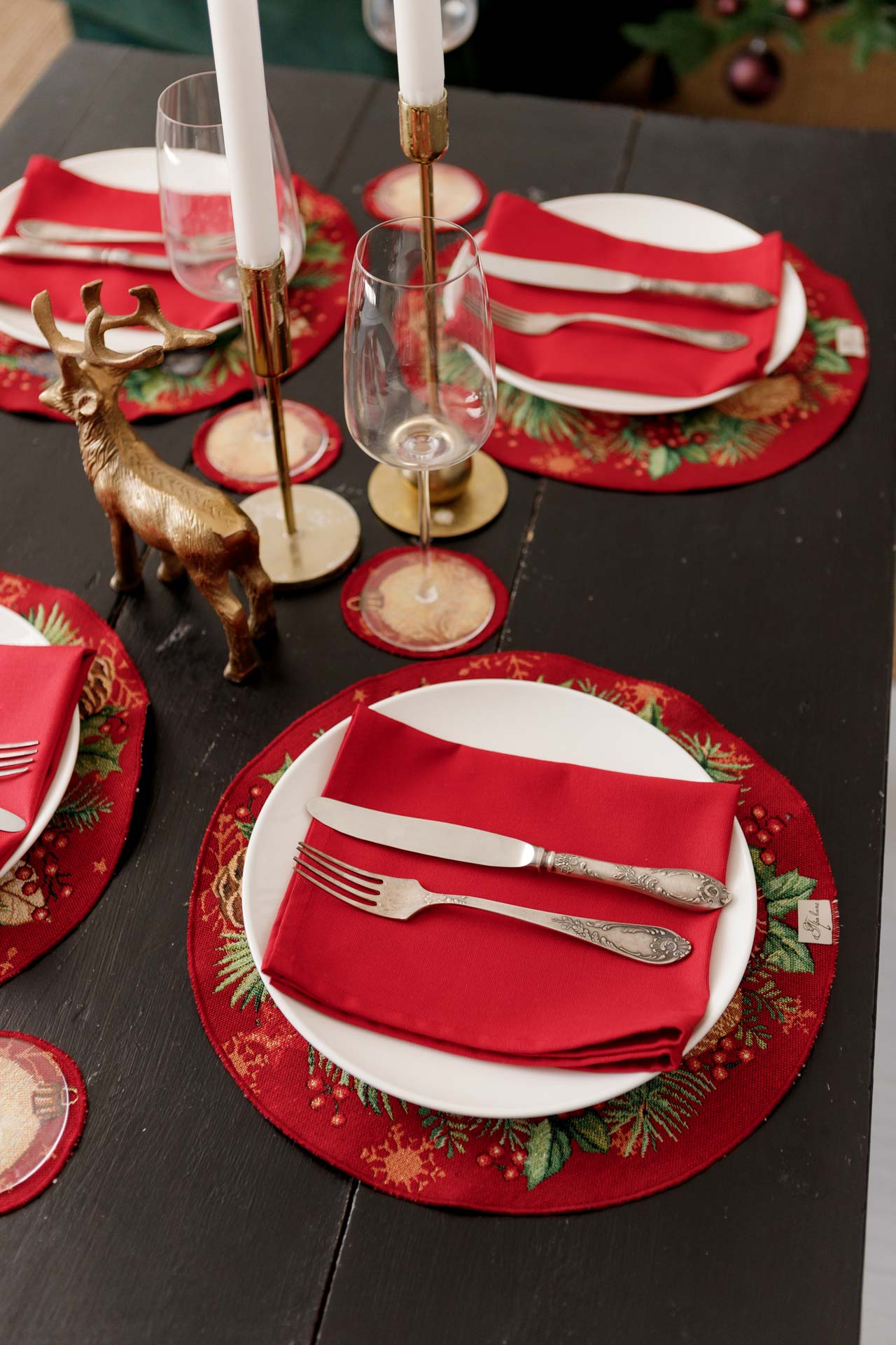 Woven tapestry holiday placemats with pine boughs and ornament details