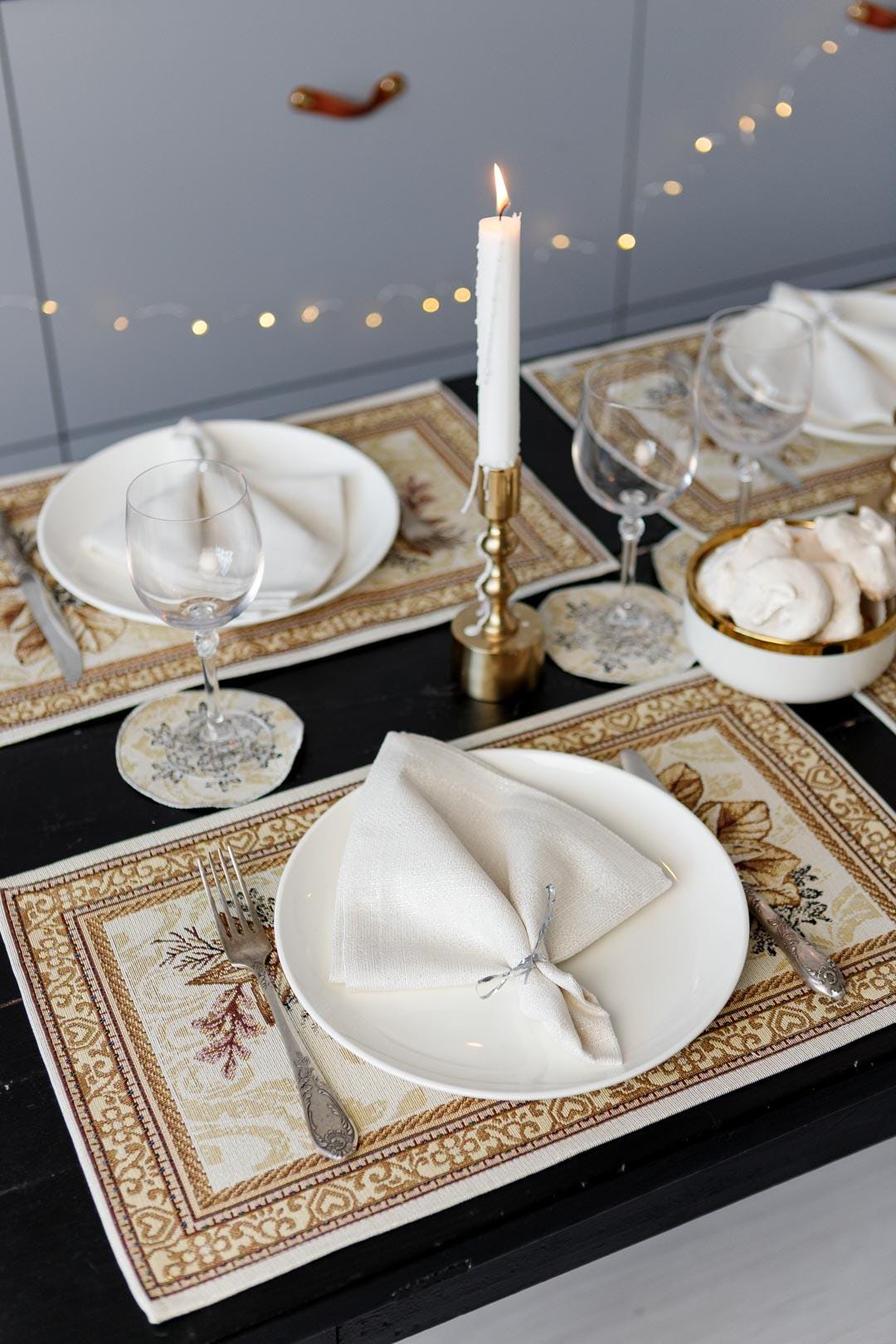 Woven tapestry placemat with Christmas poinsettia flower design. Beige and gold. Made in Ukraine.