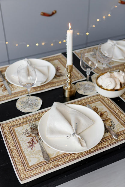 Woven tapestry placemat with Christmas poinsettia flower design. Beige and gold. Made in Ukraine.