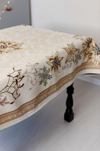 Woven tapestry tablecloth with Christmas poinsettia flower design. Beige and gold. Made in Ukraine.