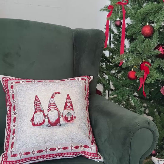 Video of Set of Christmas tapestry pillowcases with gnomes and cottage in cozy holiday interior.