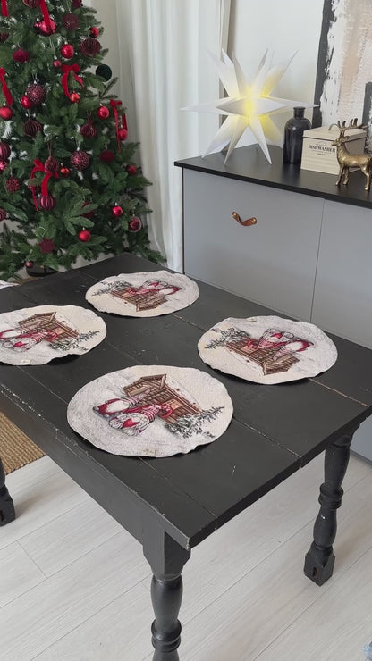 Video of Set of four round Christmas placemats displayed on a rustic dark wooden table near a decorated Christmas tree